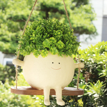 Swing planter with lush greenery