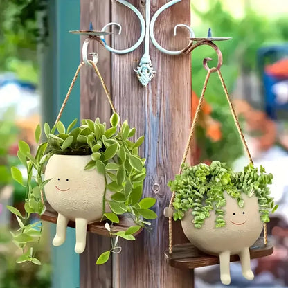 Two swing planters hanging outdoors